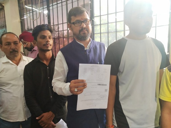 Uttar Pradesh transport minister Ashok Kataria stands in queue at RTO office in Lucknow [Photo/ANI] 