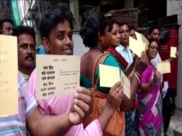 TMC workers sending postcards to Prime Minister Narendra Modi at Dum Dum on Tuesday. Photo/ANI