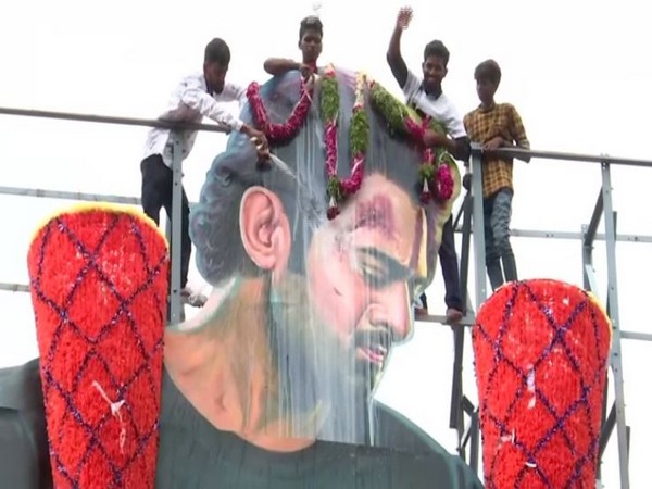 Fans of Prabhas pouring milk on his cutout in Hyderabad
