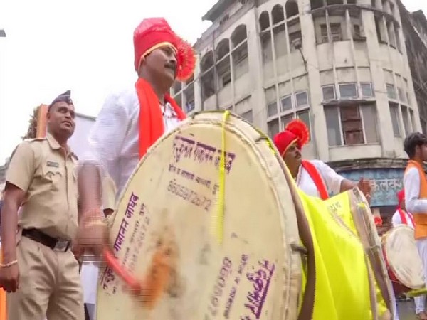 Traditionally dressed inmates of Yerwada Central Jail play drums during the Ganpati procession