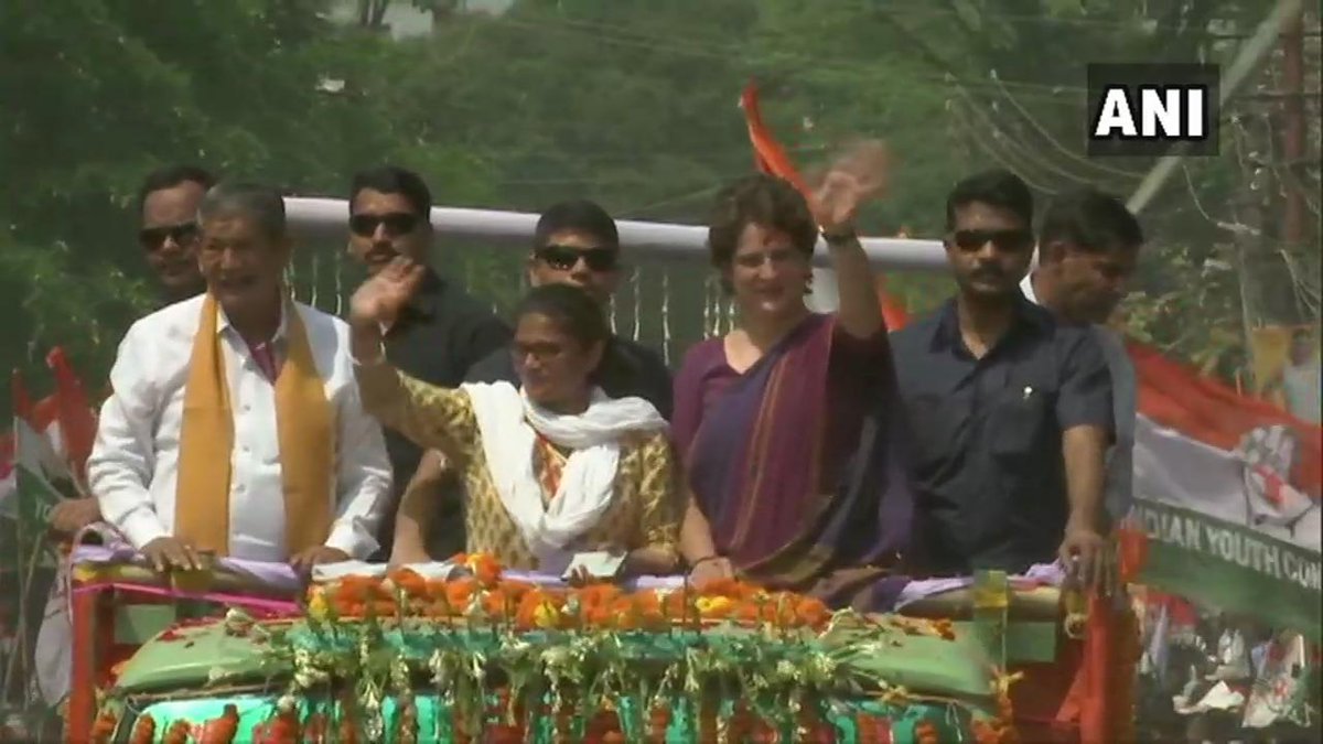 Congress party star campaigner Priyanka Gandhi along with Harish Rawat and Sushmita Dev while holding roadshow in Silchar. (Photo/ ANI)