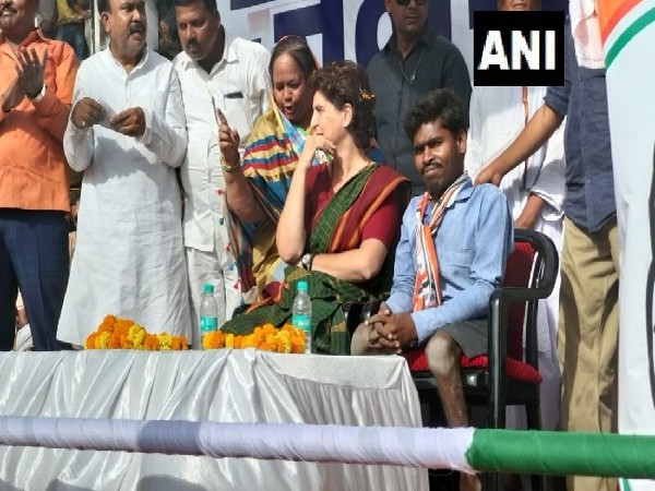 Congress leader Priyanka Gandhi Vadra along with a specially abled man during an election rally in Kushinagar, Uttar Pradesh on Friday. Photo/ANI