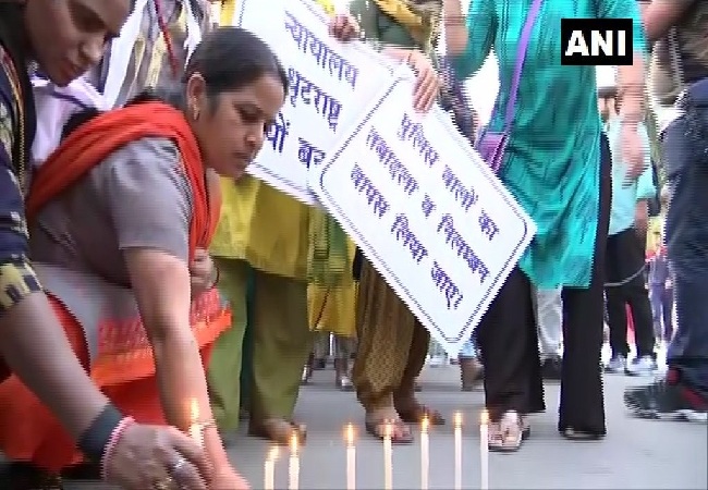 Families of policemen protest in New Delhi on Tuesday. 