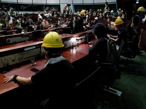 Anti-extradition bill protesters enter a chamber after they vandalised Hong Kong’s Legislative Council on Monday