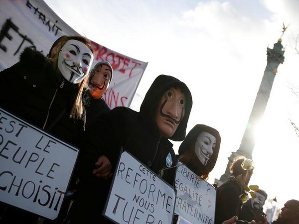 Protestors wear Guy Fawkes and Salvador Dali masks as they attend a demonstration during the 31st consecutive day of strike against French government's pensions reform plans in Paris on Saturday.