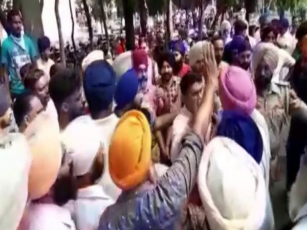 People protesting outside the District Collector's (DC) office in Gurdaspur in Punjab on Thursday. Photo/ANI