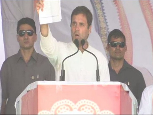 Congress president Rahul Gandhi showing documents while addressing a public rally in Ujjain on Tuesday. Photo/ANI