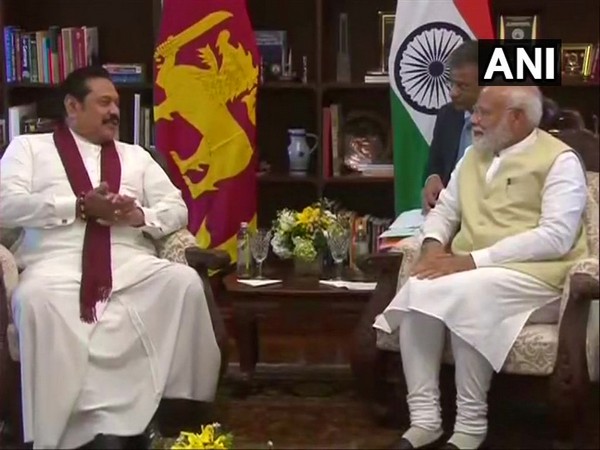 Sri Lankan Leader of Opposition, Mahinda Rajapaksa (L), interacts with Prime Minister Narendra Modi in Colombo on Sunday (Photo/ANI)