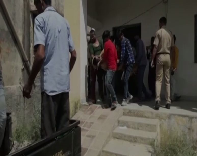 Villagers taking out bodies from the couple's house in Mal Ka Khera area of Bhilwara in Rajasthan on Saturday. (Photo/ANI)