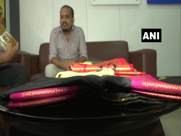 Ram Kalyan, Co-founder of 'Pickmycloth' showing handloom clothese in Hyderabad on Tuesday. (Photo/ANI)