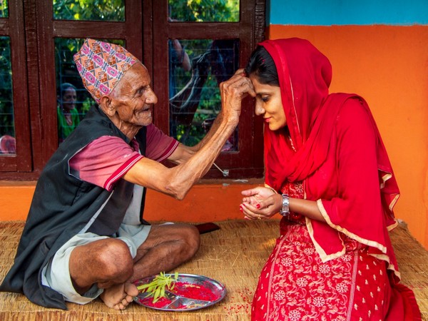 An elderly person applying Tika to a youngster. Photo/ANI