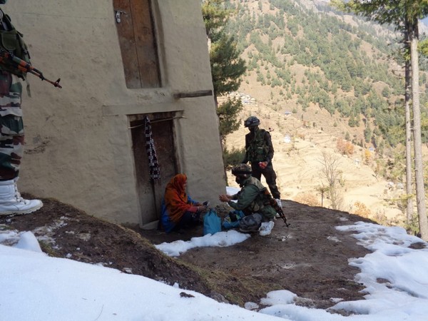Indian Army Jawans distributing medical kits and rations in a village of J-K's Ramban district.
