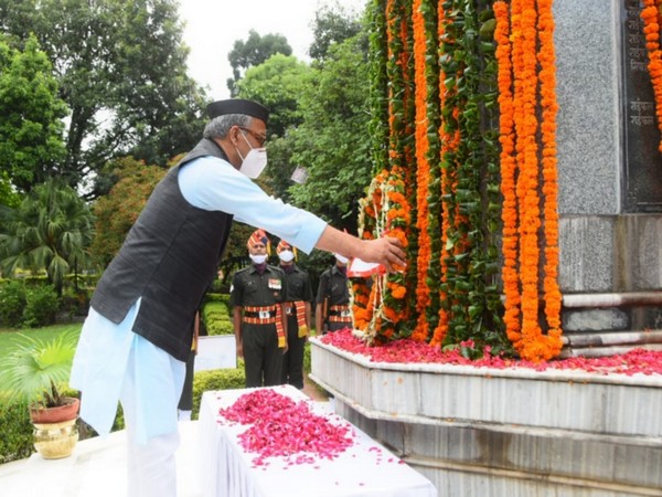 Uttarakhand Chief Minister Trivendra Singh Rawat paying tribute to fallen soldiers in Dehradun on Sunday. (Photo/ANI)