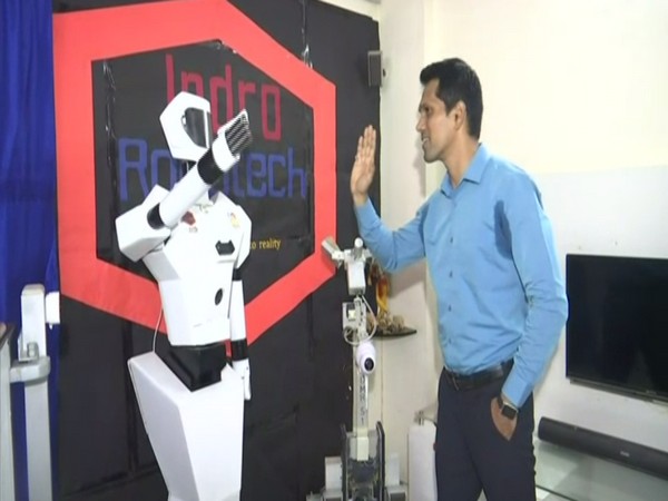 Santosh Hulawale with Service Humanoid Robot. (Photo/ ANI)
