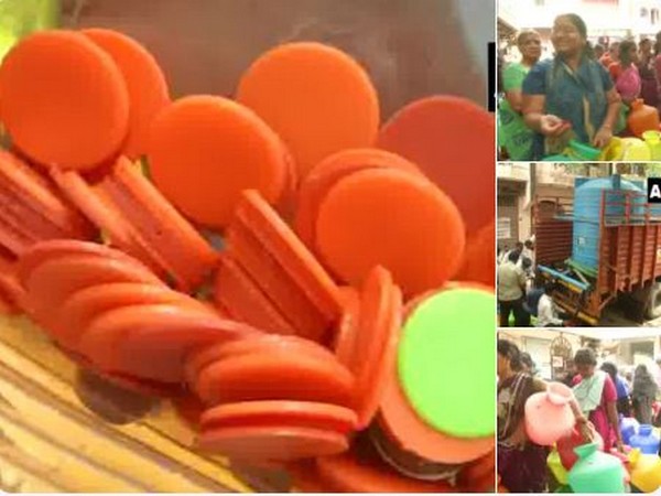 Residents buying tokens to avail water service in Royapettah. Photo/(ANI)