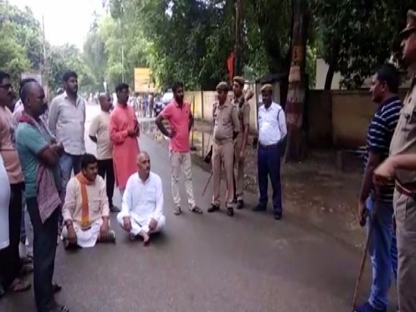 BJP leader Anil Singh sitting on Dharna after accusing police personnel of misbehaviour. (Photo/ANI)