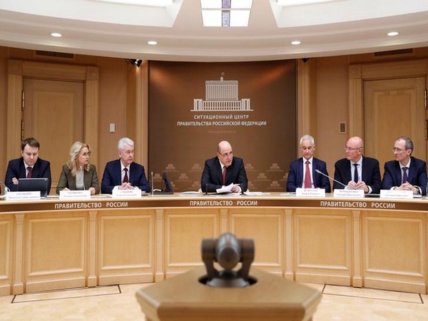 Russian Prime Minister Mikhail Mishustin (C)