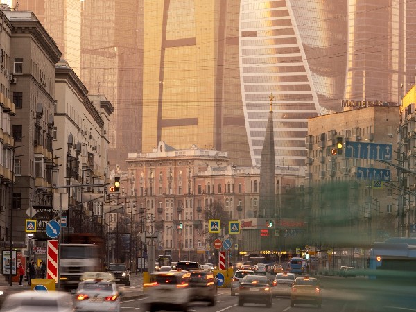 Cars drive along a road near the skyscrapers of the Moscow International Business Centre, also known as 