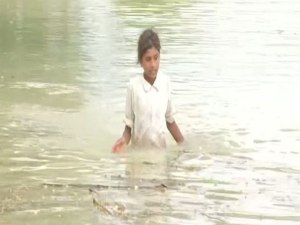 A girl moving through the flood in Bihar's Samastipur
