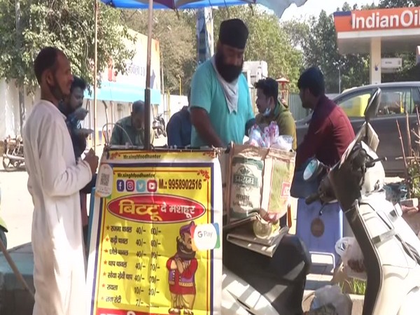 Balbir Singh at work, selling food on his scooty. (ANI/photo)