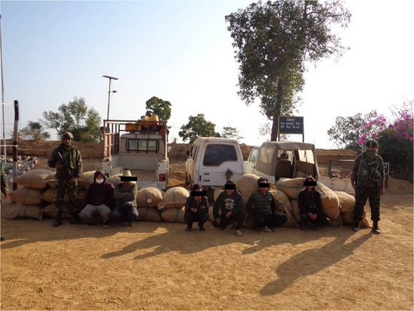 Visual of Assam Rifles with recovered contrabands and carriers 