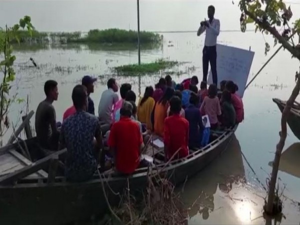 A teacher taking classes on a boat in Manihari of Katihar. (Photo/ANI)