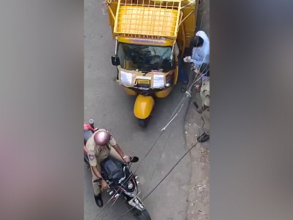 Video grab of the policeman taking bribe. Photo/ANI