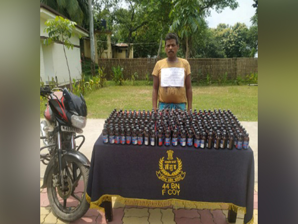 Arrested smuggler with the Phensedyl bottles seized from India-Bangladesh border