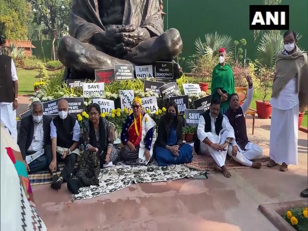 Protest by 12 Rajya Sabha MPs against their suspension at Gandhi Statue in Parliament premises (Photo/ANI)