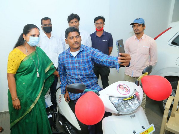 Nizamabad MLC Kalvakuntla Kavitha (left) with the beneficiary and the scooter.