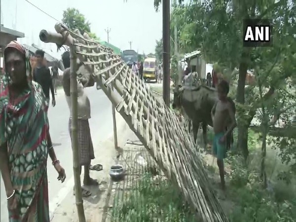Villagers erecting a temporary shelter roadside in Darbhanga, Bihar on July 21. Photo/ANI