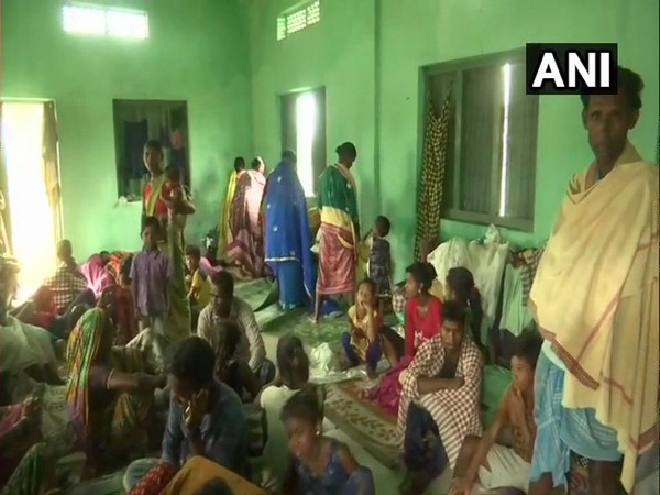 People take refuge in a shelter in Ichchapuram town of Srikakulam district.