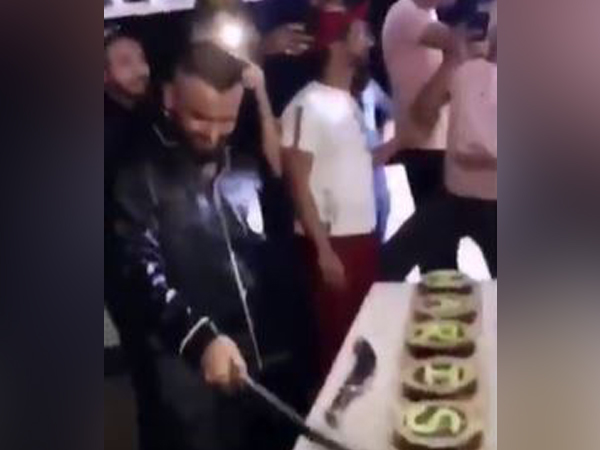 Man cuts cakes with a sword, held. Photo/ANI