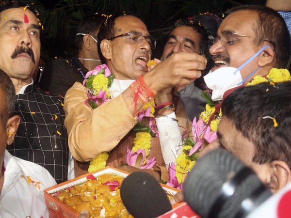 Chief Minister Shivraj Singh Chouhan and BJP State President VD Sharma with party workers celebrate party's victory in Bhopal.