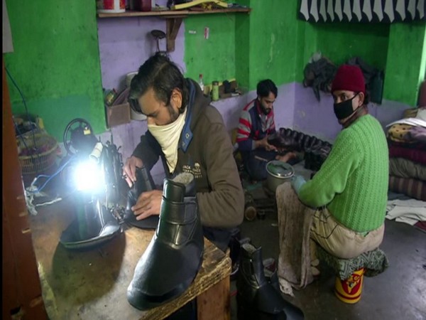 Shoe makers making fur shoes in Sringar. (Photo/ANI)