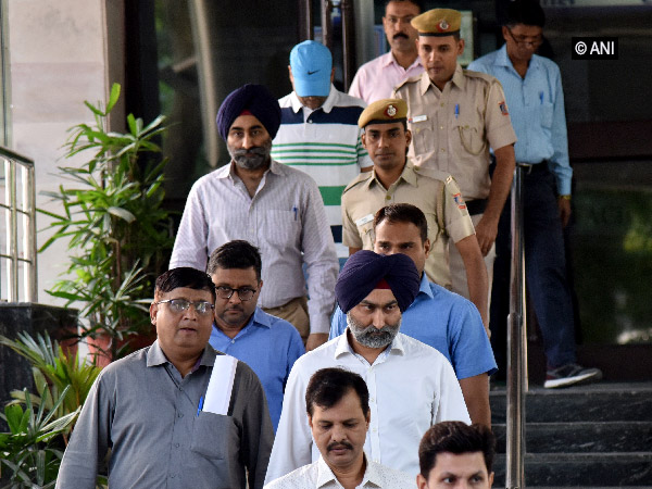 Malvinder, Shivinder Singh and other accused coming out of Saket court in New Delhi on Thursday. Photo/ANI