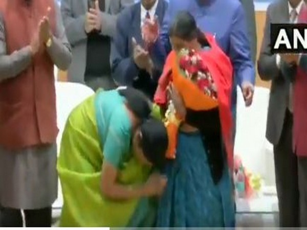 Defence Minister Nirmala Sitharaman touching feet of mother of a braveheart during an event on Monday in Dehradun.