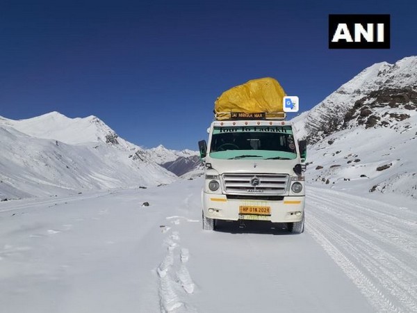 A truck crossing the Baralacha La in Lahaul and Spiti district on Sunday amid snowfall. Photo/ANI