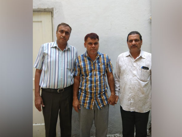 Delhi Police Special Cell officials with the arms smuggler nabbed on Saturday. Photo/ANI