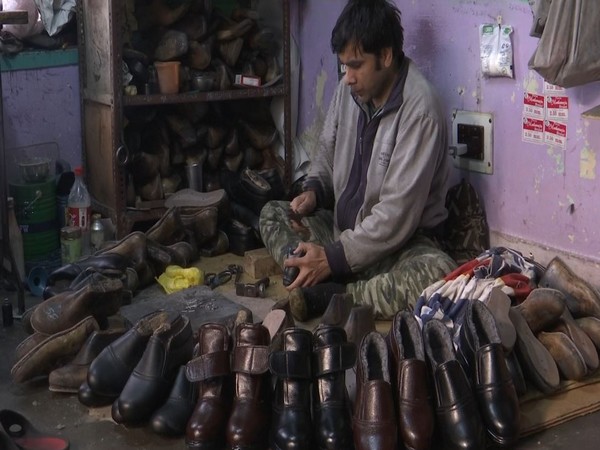 Shoe maker making fur shoes in Srinagar. (Photo/ANI)
