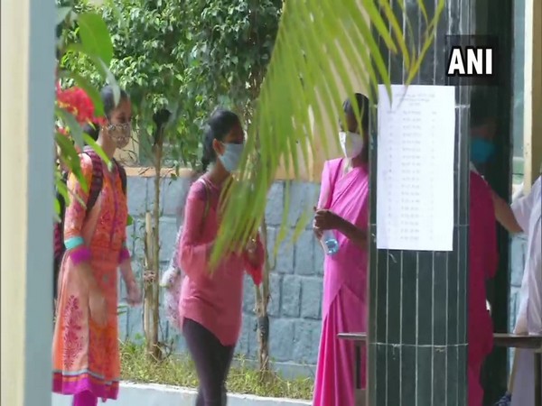An examinee being provided hand sanitiser at a CET centre at Shivamogga. (Photo/ANI)