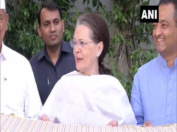 Congress President Sonia Gandhi handing over a 'chadar' to All Indian Minority Congress delegation in New Delhi on Wednesday.