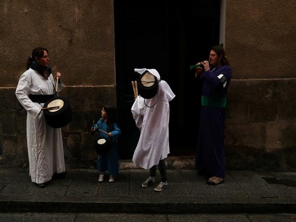 People prepare to play drums outside their home after the Way to the Calvary procession was cancelled due to the coronavirus outbreak in Cuenca, Spain