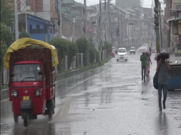 People walking on a road in Srinagar on Wednesday. Photo/ANI