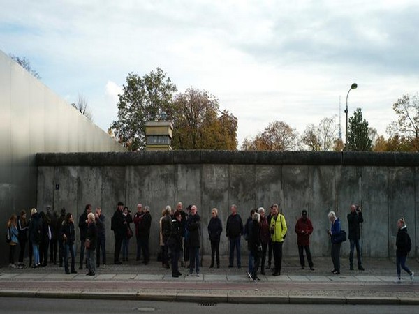 Tourists visit remains of the Berlin Wall at the Wall memorial on Bernauer Strasse in Berlin, Germany on Saturday