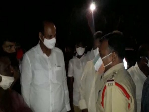 People gather at the site where the body was found.