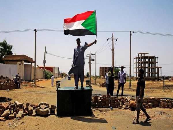 A pro-democracy protester holds the Sudanese flag during demonstrations on June 5 (Photo/Reuters)