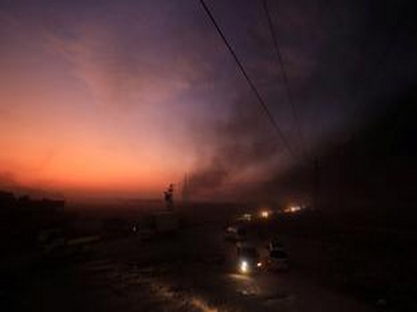 Vehicles are seen as people flee Ras al Ain town, Syria, on Wednesday