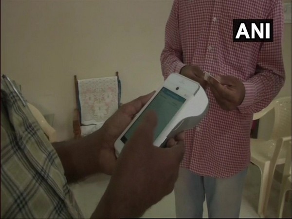Kalaburagi City Corporation employee collecting taxes through EDC device 