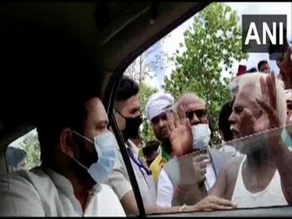 RJD leader Tejashwi Yadav interacting with flood affected people in Bihar on Sunday. 